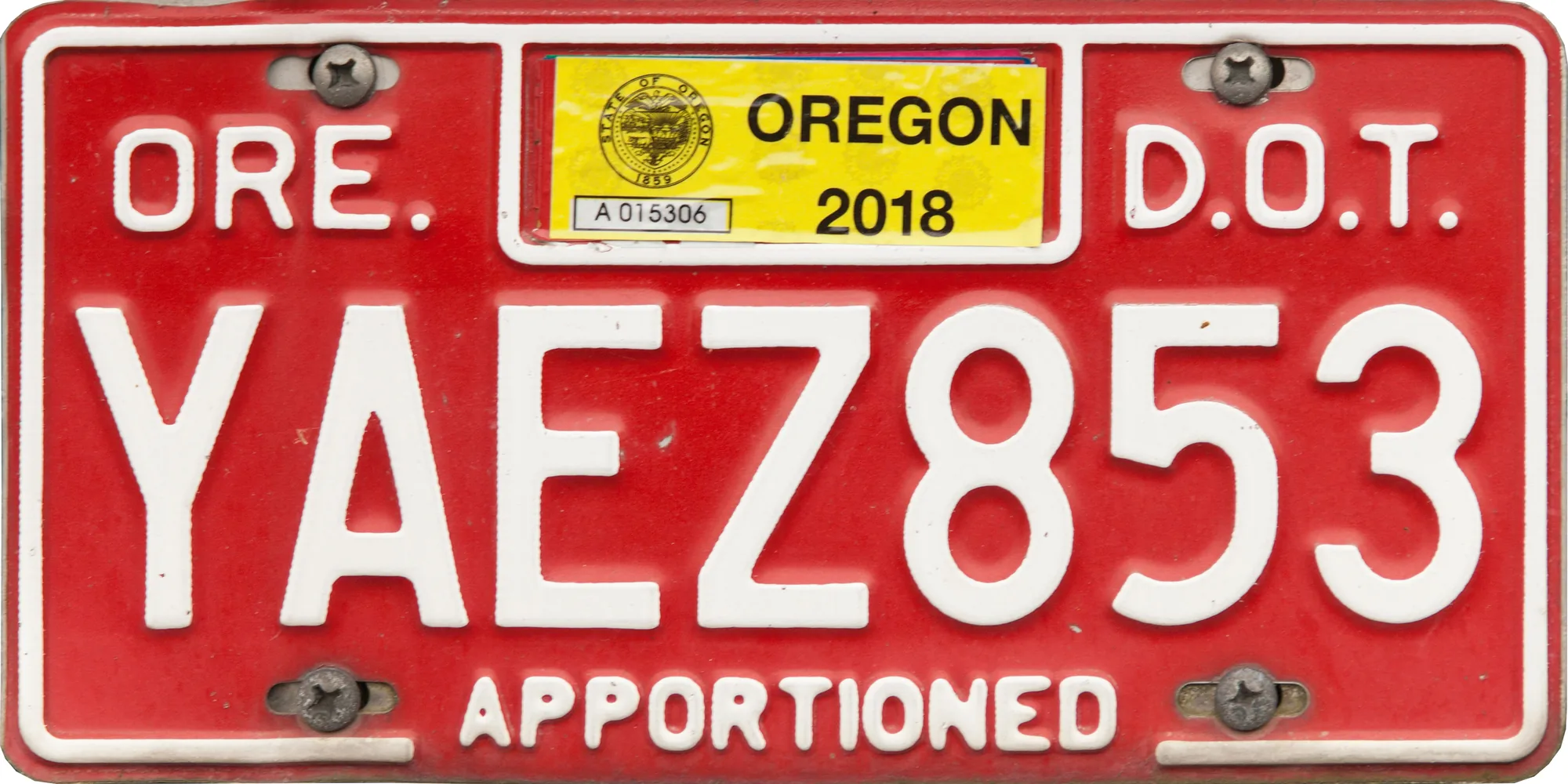 Oregon license plate with white lettering on a red background, the number 12345, and Apportioned along the bottom