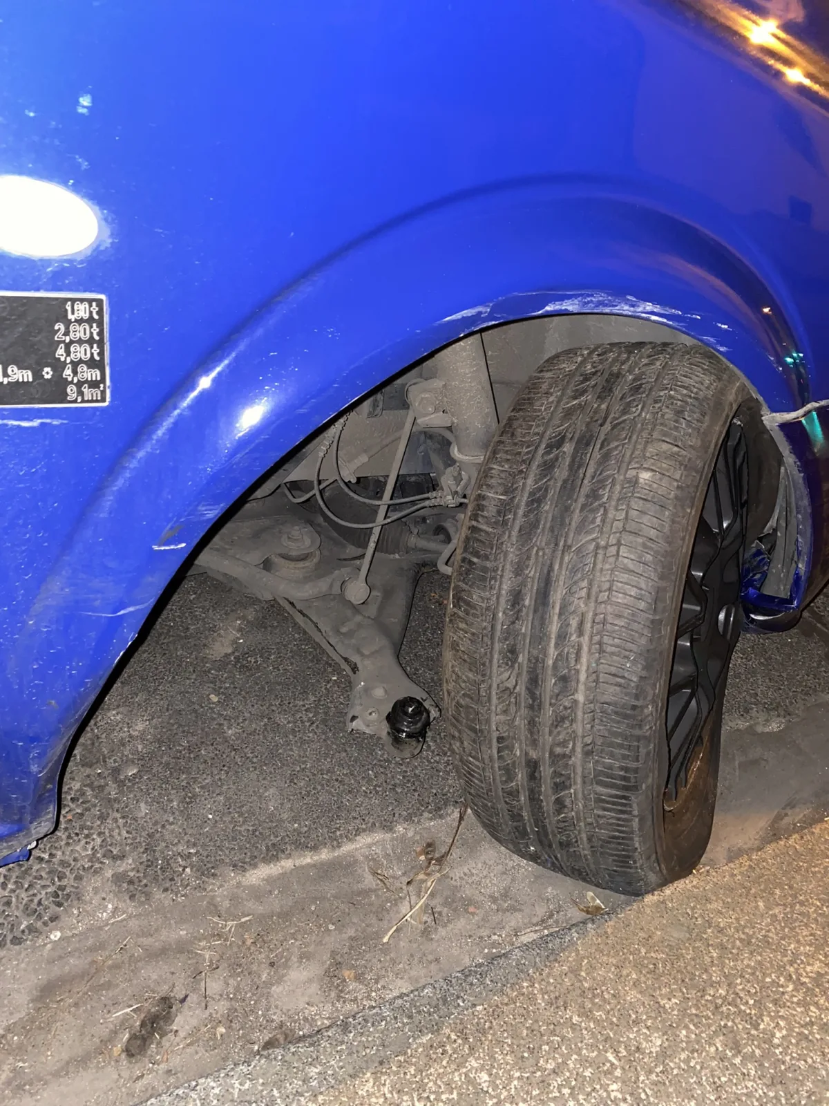 Vehicle with its front wheel tilted sharply in the wheel opening