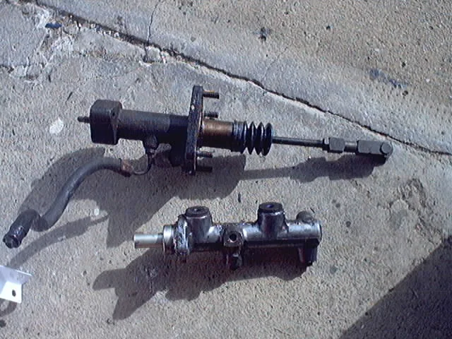 Removed hydraulic brake components with pushrods and hydraulic connections