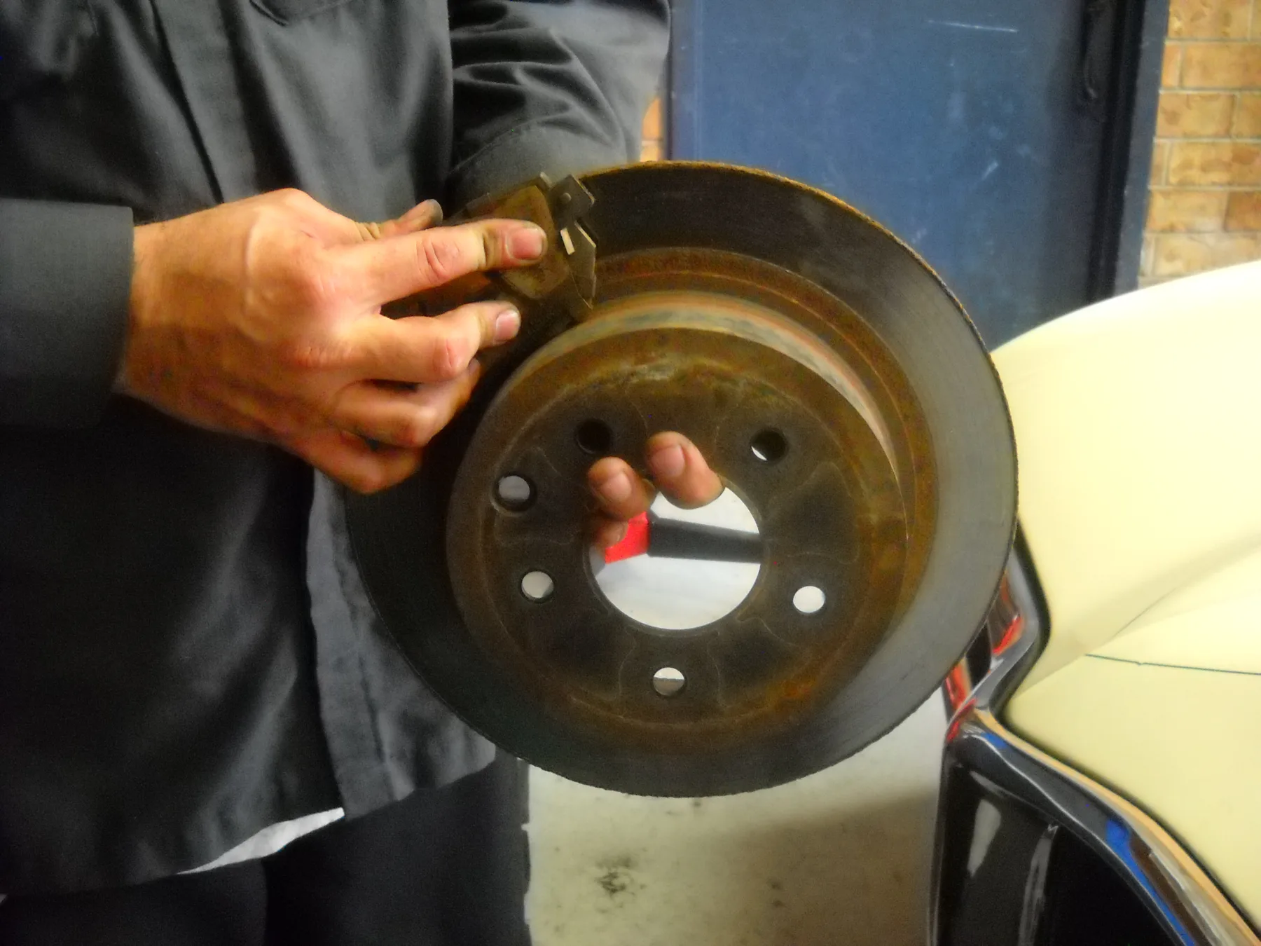 Brake pad held beside a disc rotor
