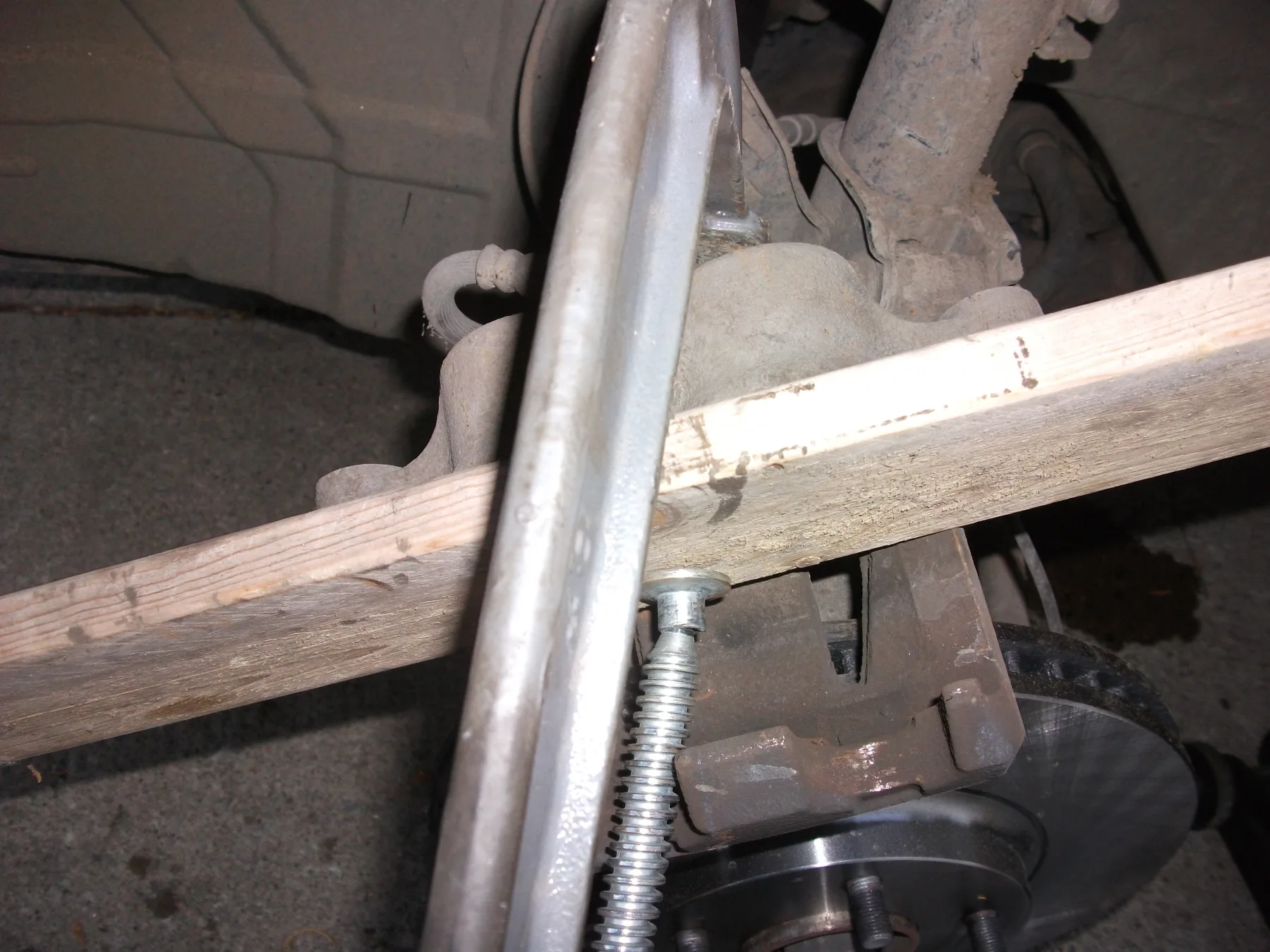 A clamp being used against a brake-caliper piston during service