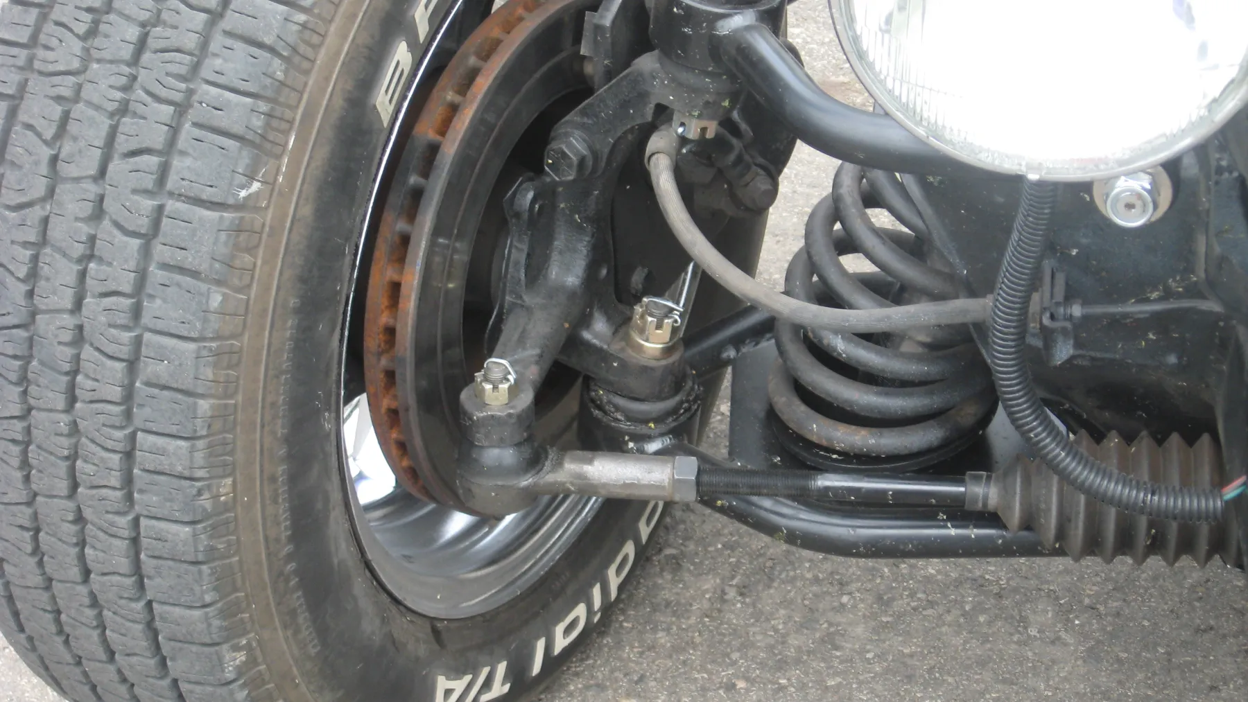 Modified front suspension with a coil spring and a separate shock absorber