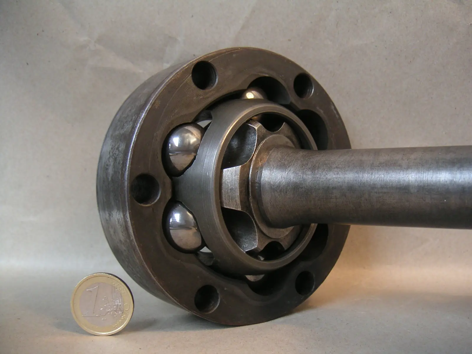 Exposed ball-type CV joint with its housing, cage and shaft visible