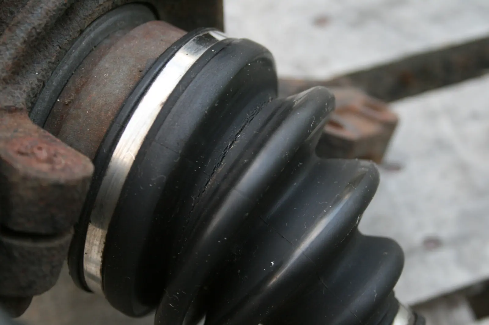 CV-joint boot with a visible tear near its clamp