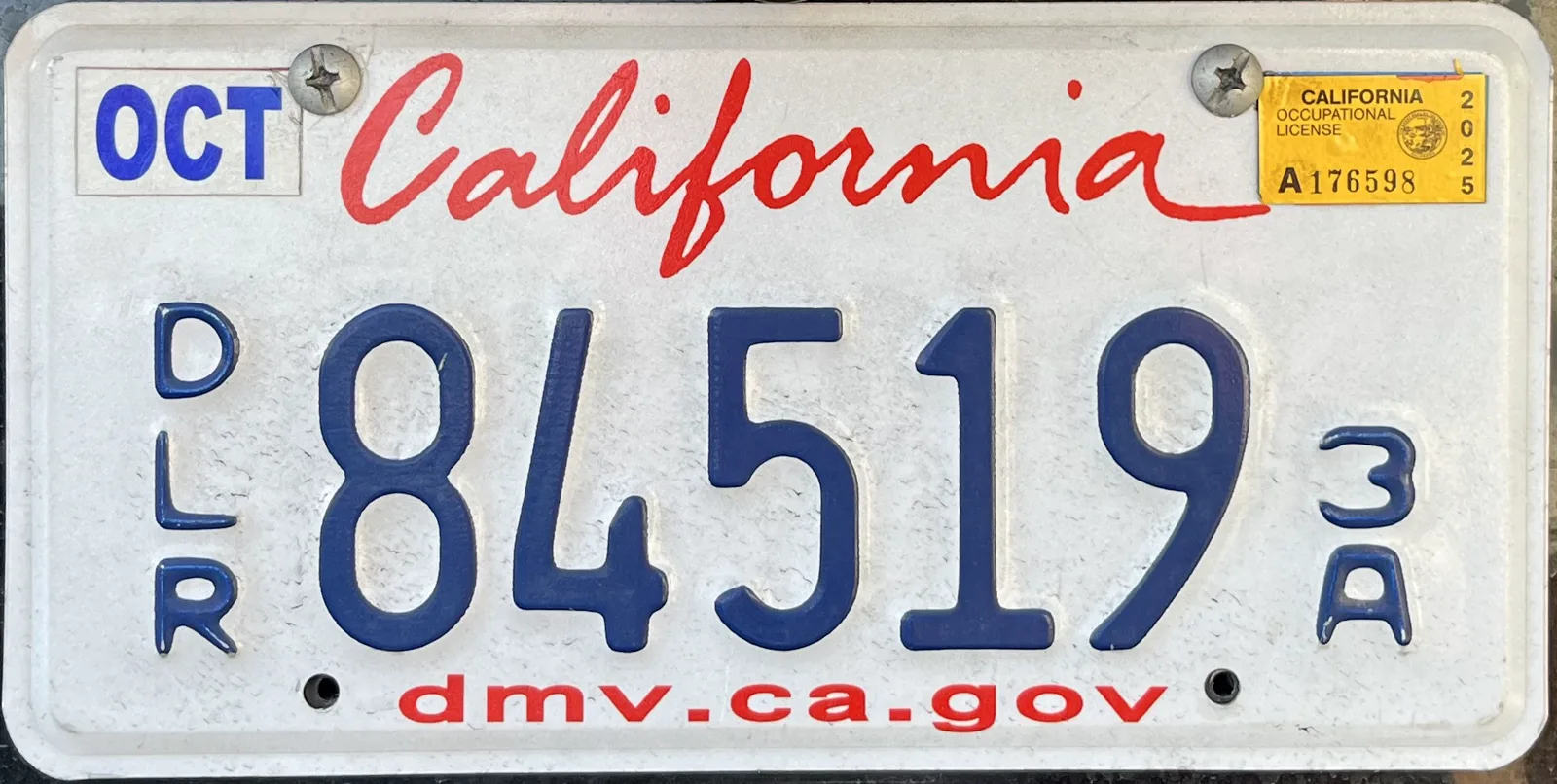 California dealer plate showing 84519 with vertical DLR at left