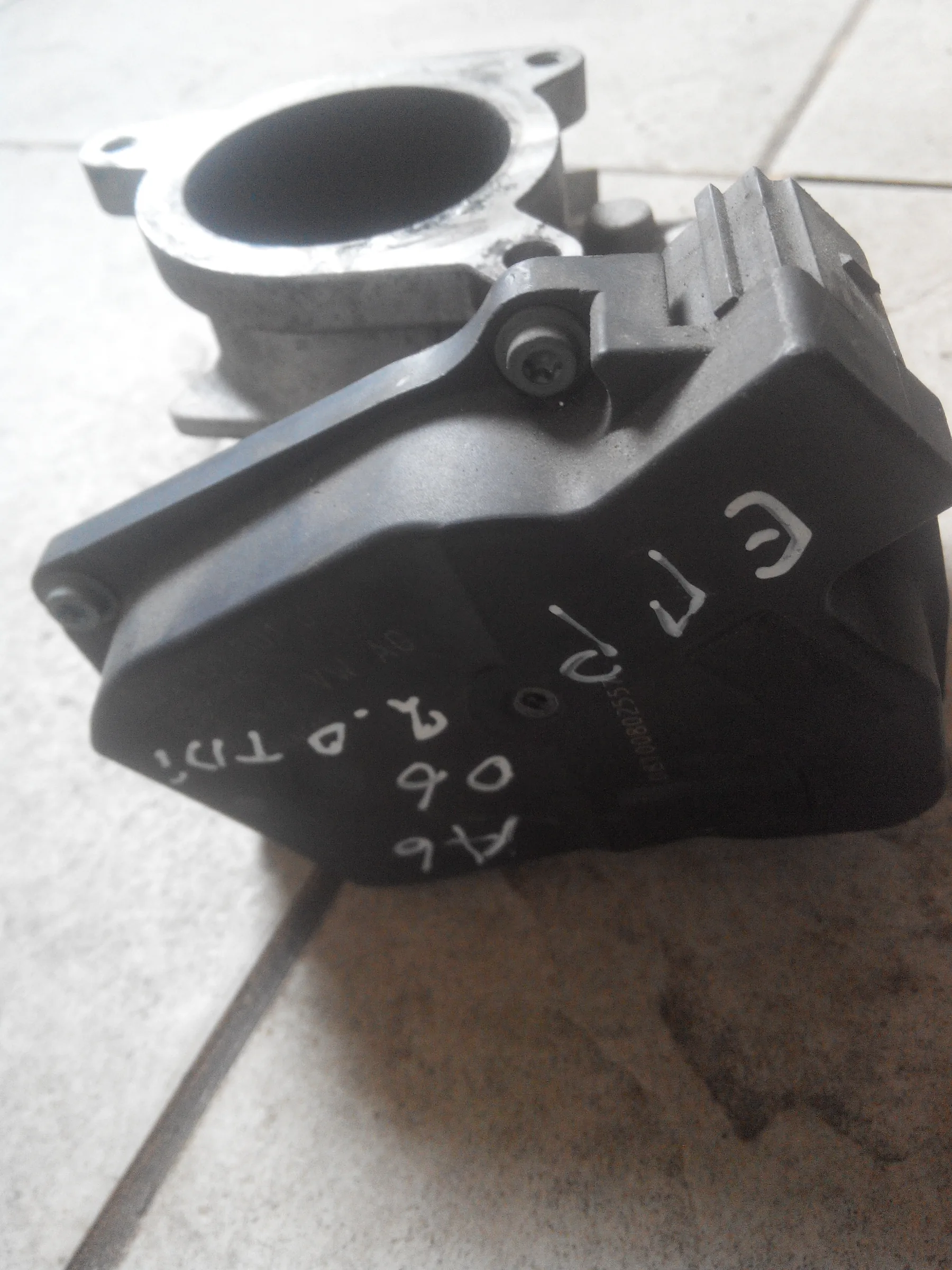 Volkswagen EGR valve 03G131501J, a black electric actuator on a cast body with an outlet pipe and a wiring connector