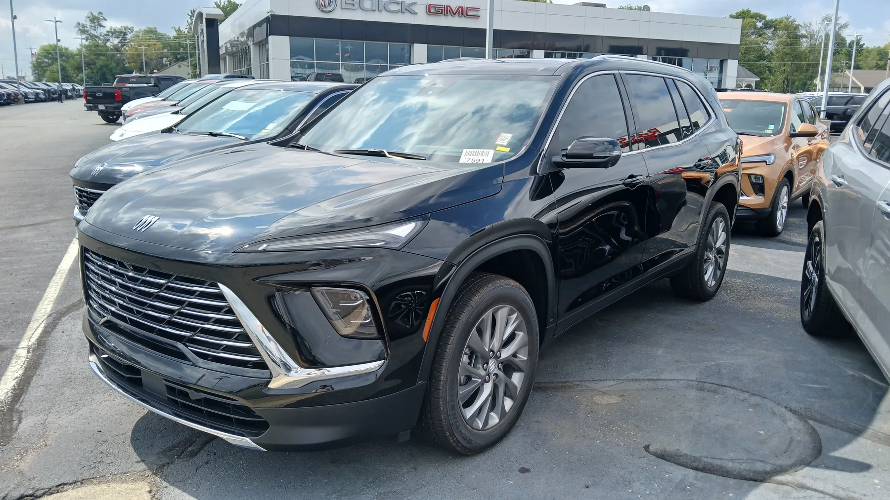 Front view of a 2025 Buick Enclave Preferred with check-shaped LED daytime running lamps above a bright grille