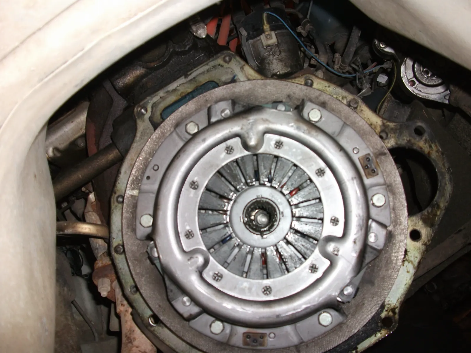 Engine-side clutch assembly with the pressure plate still installed and starter teeth visible around the outer rim