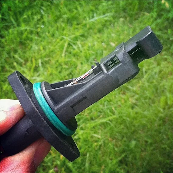 Mass-airflow probe held outside its housing, with its sensing window exposed