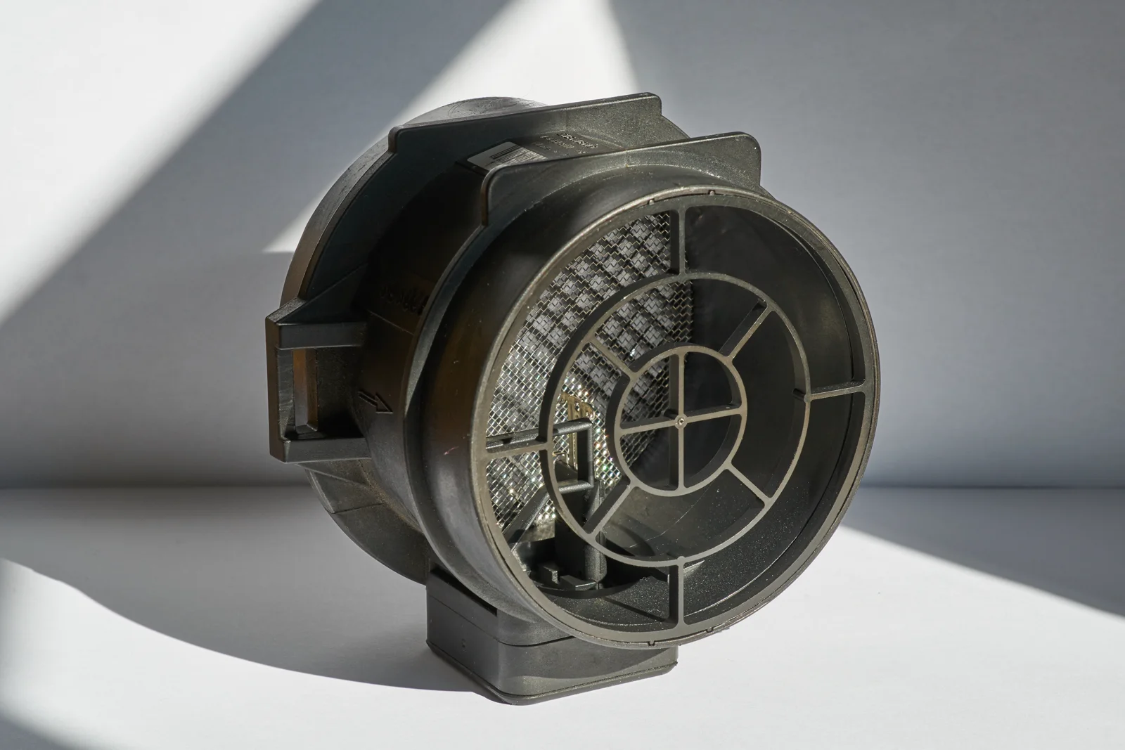 Mass-airflow sensor housing with a mesh inlet and electrical connector